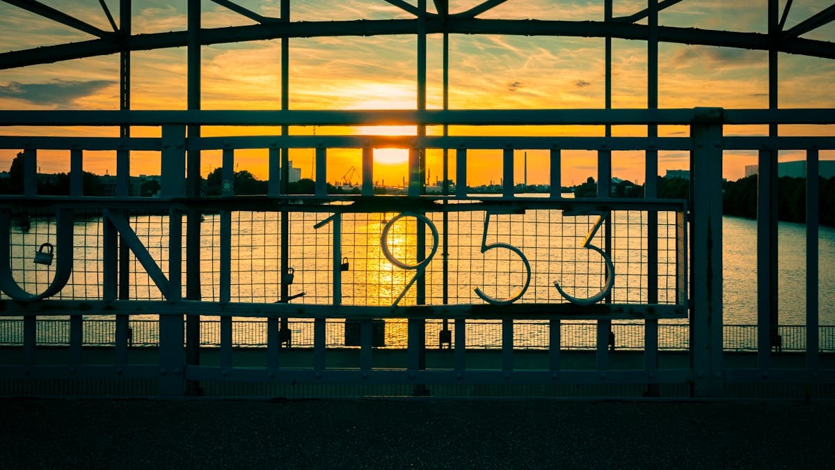 Captivating sunset view through a historic bridge in Hamburg, highlighting the year 1953.